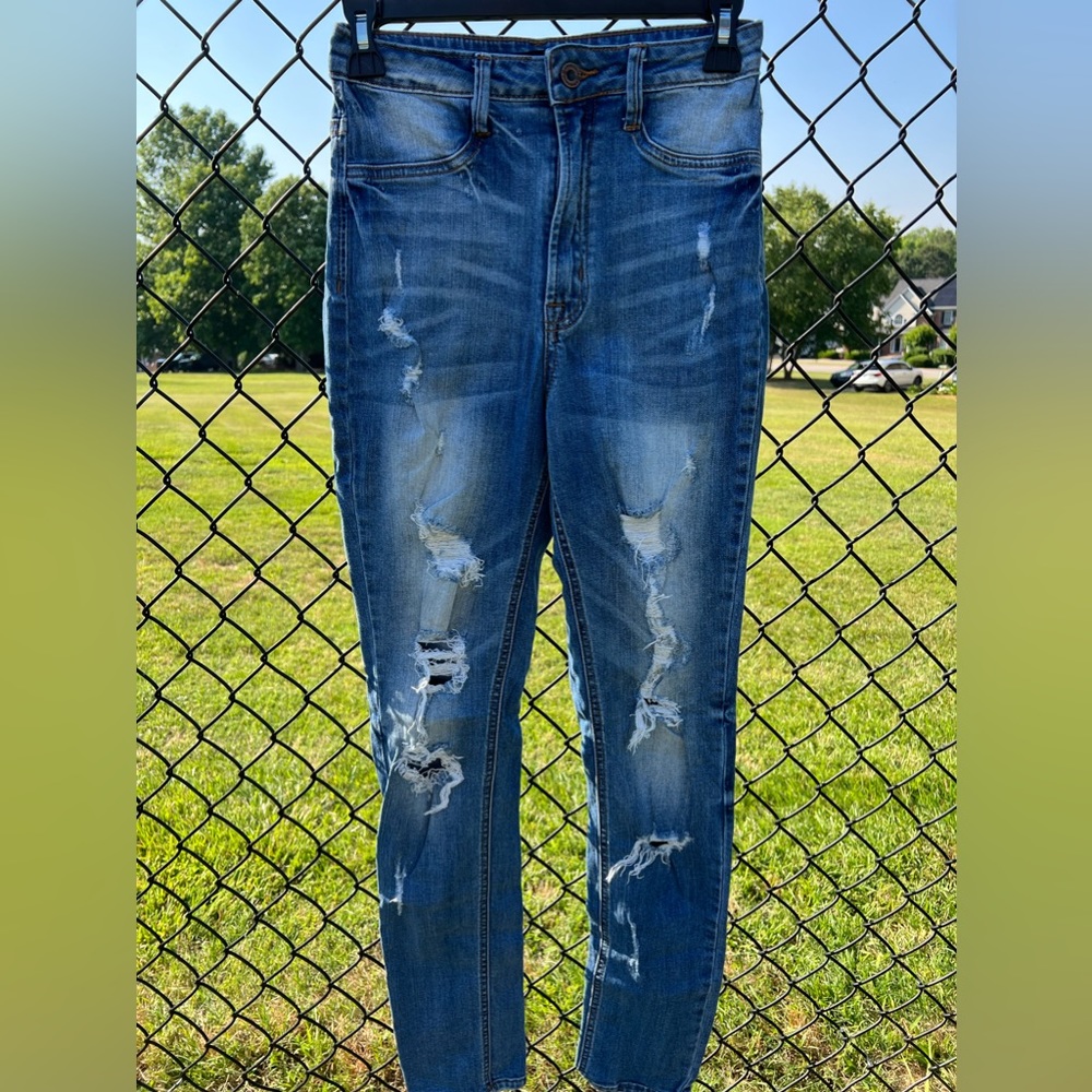 Fashion nova jeans with various rips on front and back in size 9.
